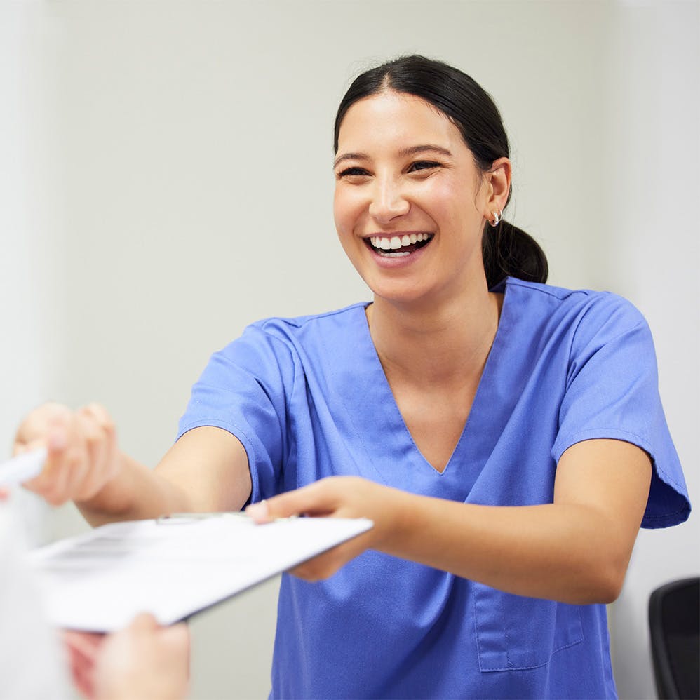 nurse handing patient a form