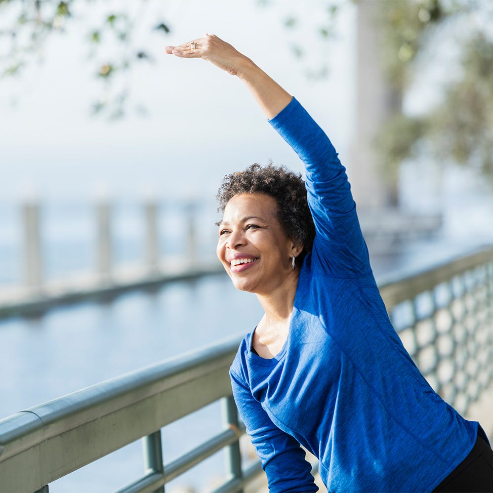 woman stretching at marina