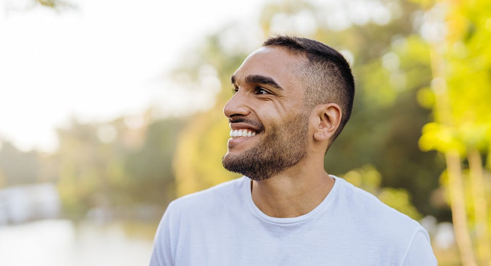 man smiling while turning head