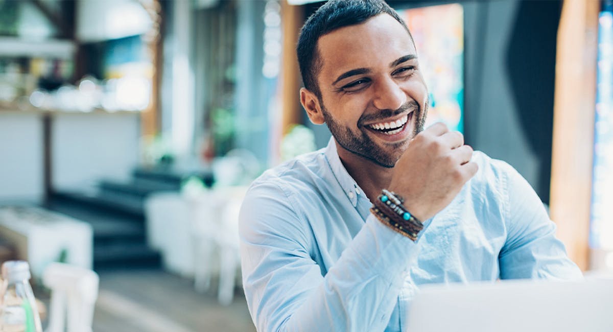 man sitting and smiling at restaurant