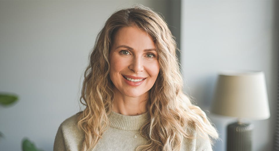 woman in cashmere sweater smiling