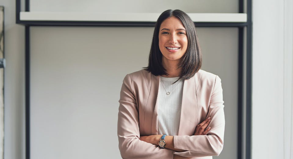 woman in conference room with arms crossed