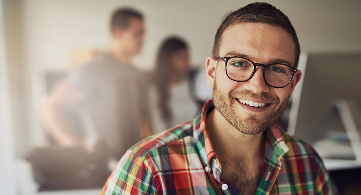 man with glasses smiling