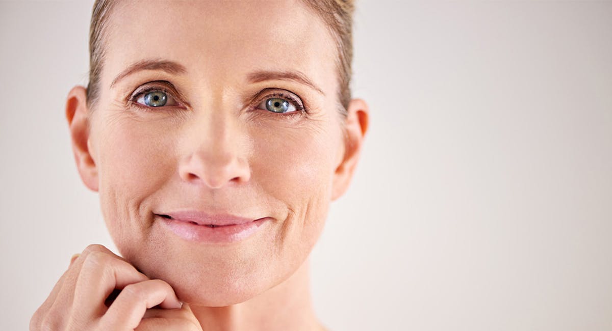 woman with hand under chin