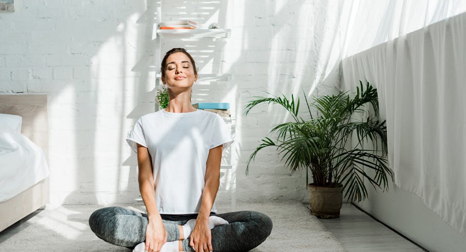 woman sitting on ground in yoga pose
