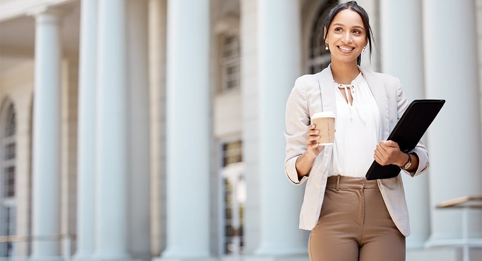 business woman enjoying coffee outside office