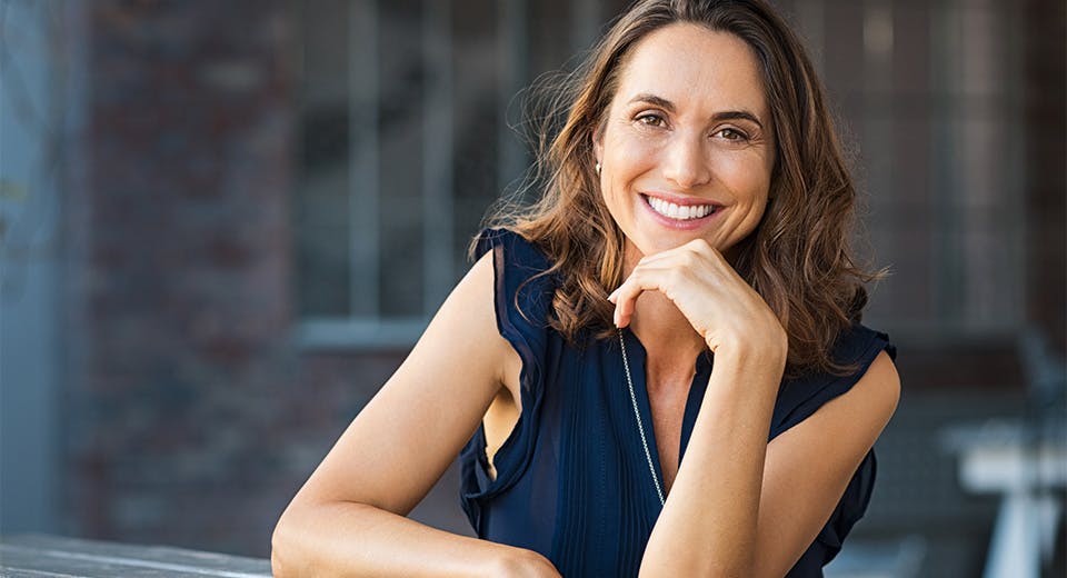 woman leaning on railing and smiling