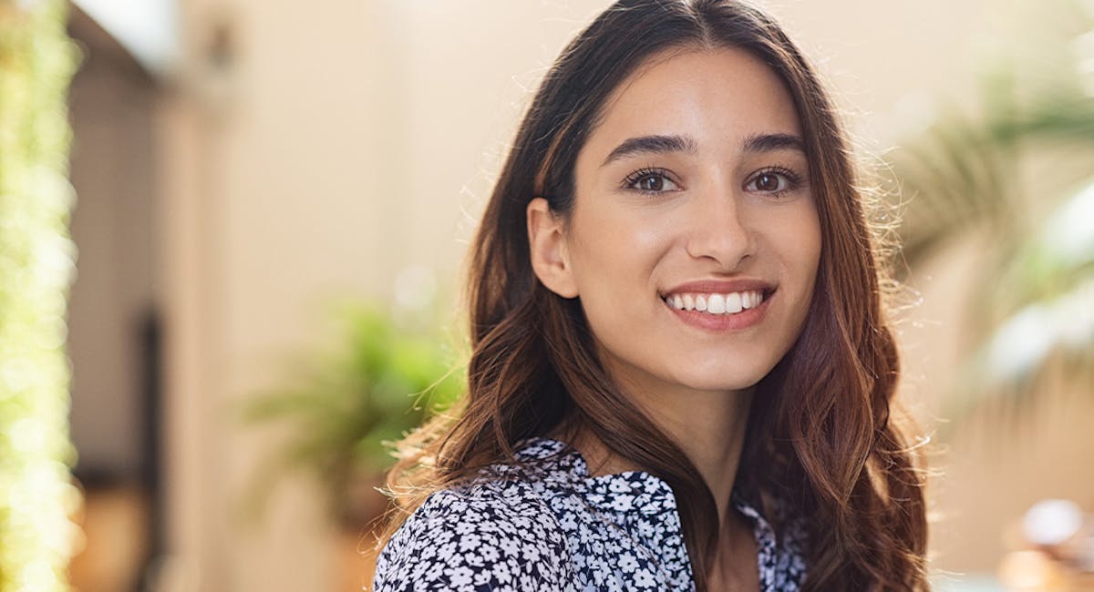 woman smiling in floral blouse