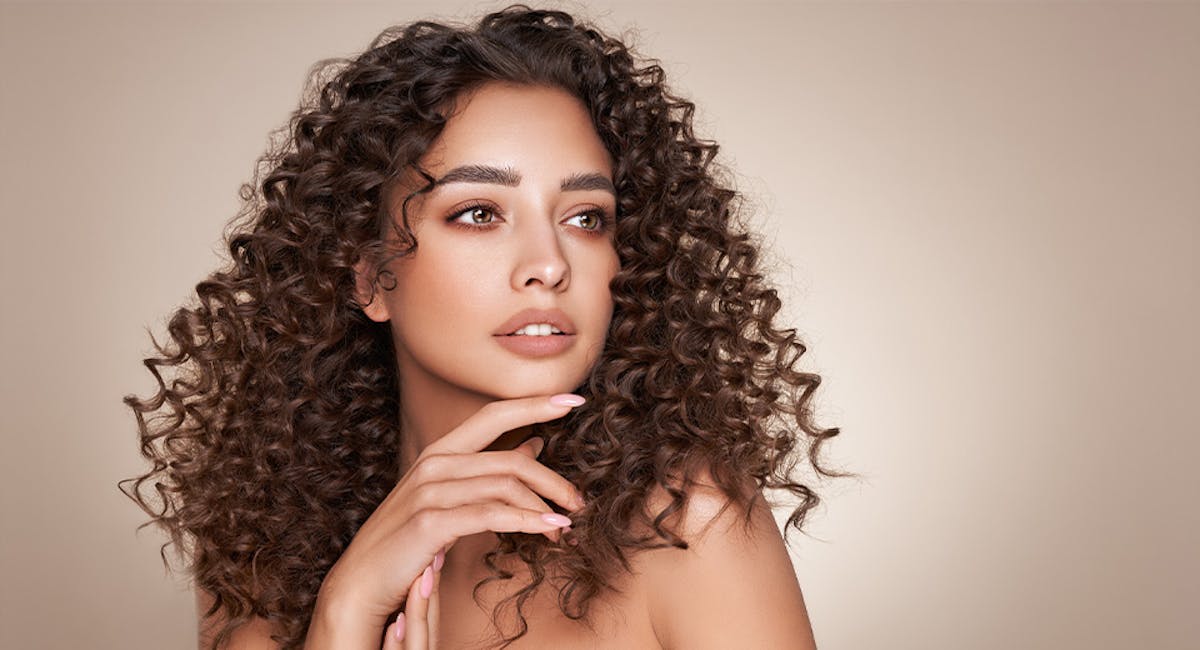 woman turned to side with hand under chin