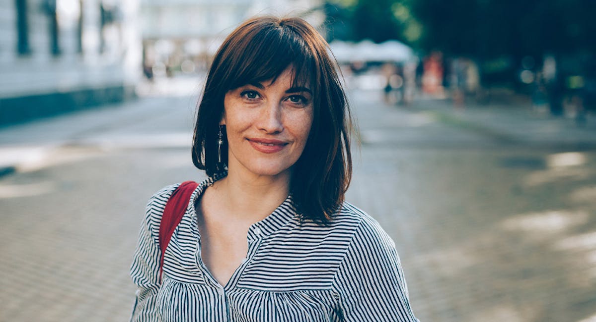 woman smiling in courtyard