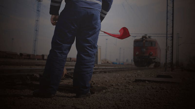 A conducter standing by a railroad