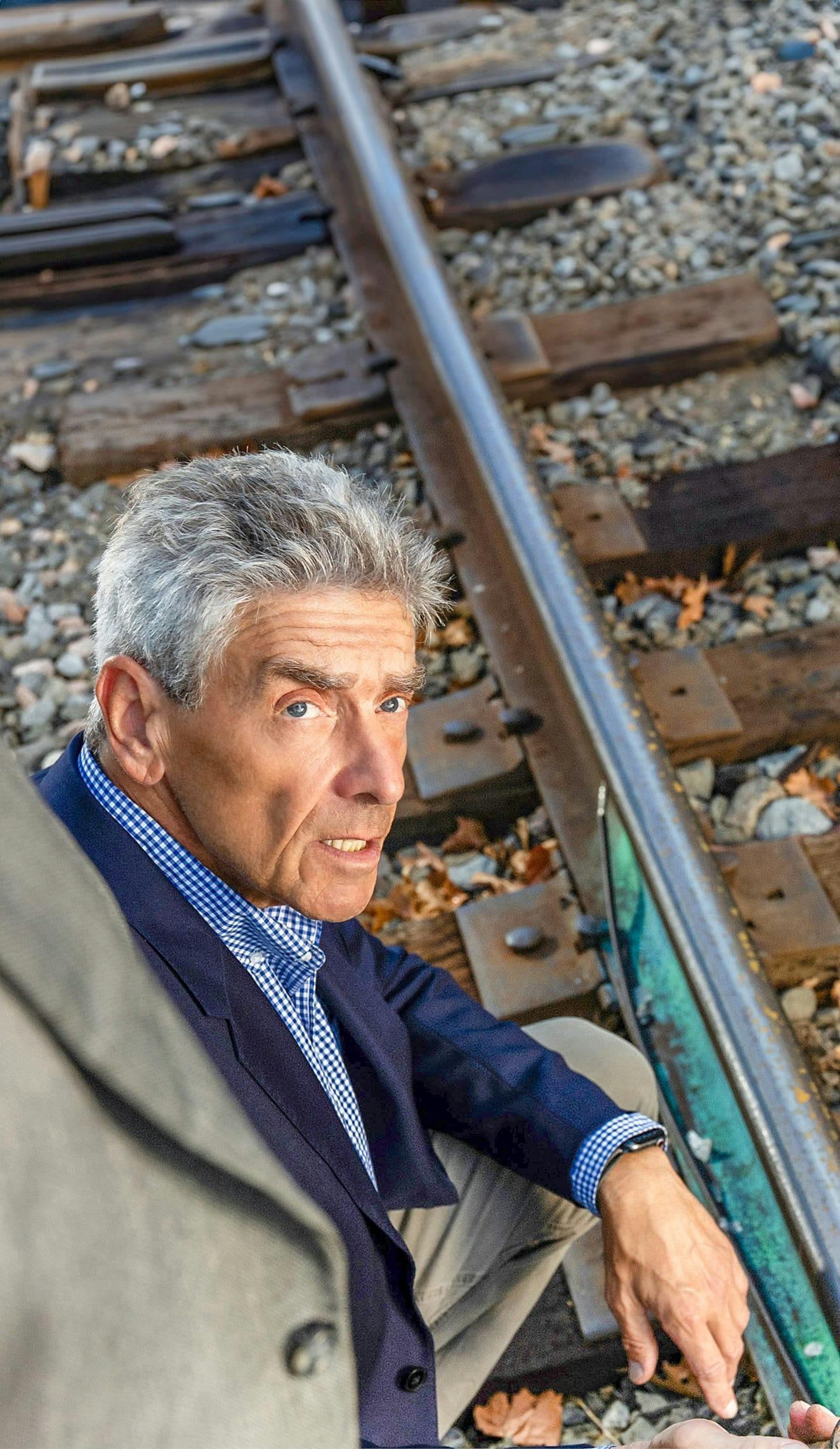 kneeling near railroad tracks