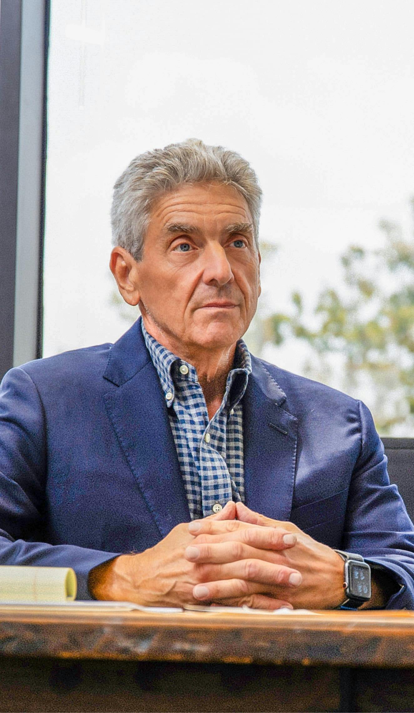 man sitting with his fingers interlinked