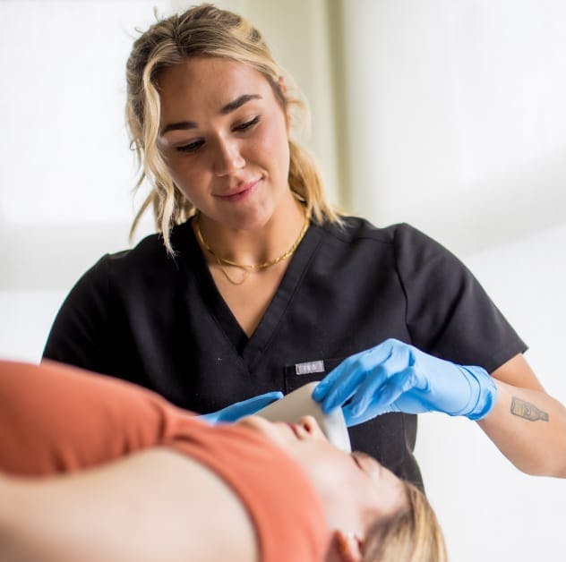 nurse touching a womans face