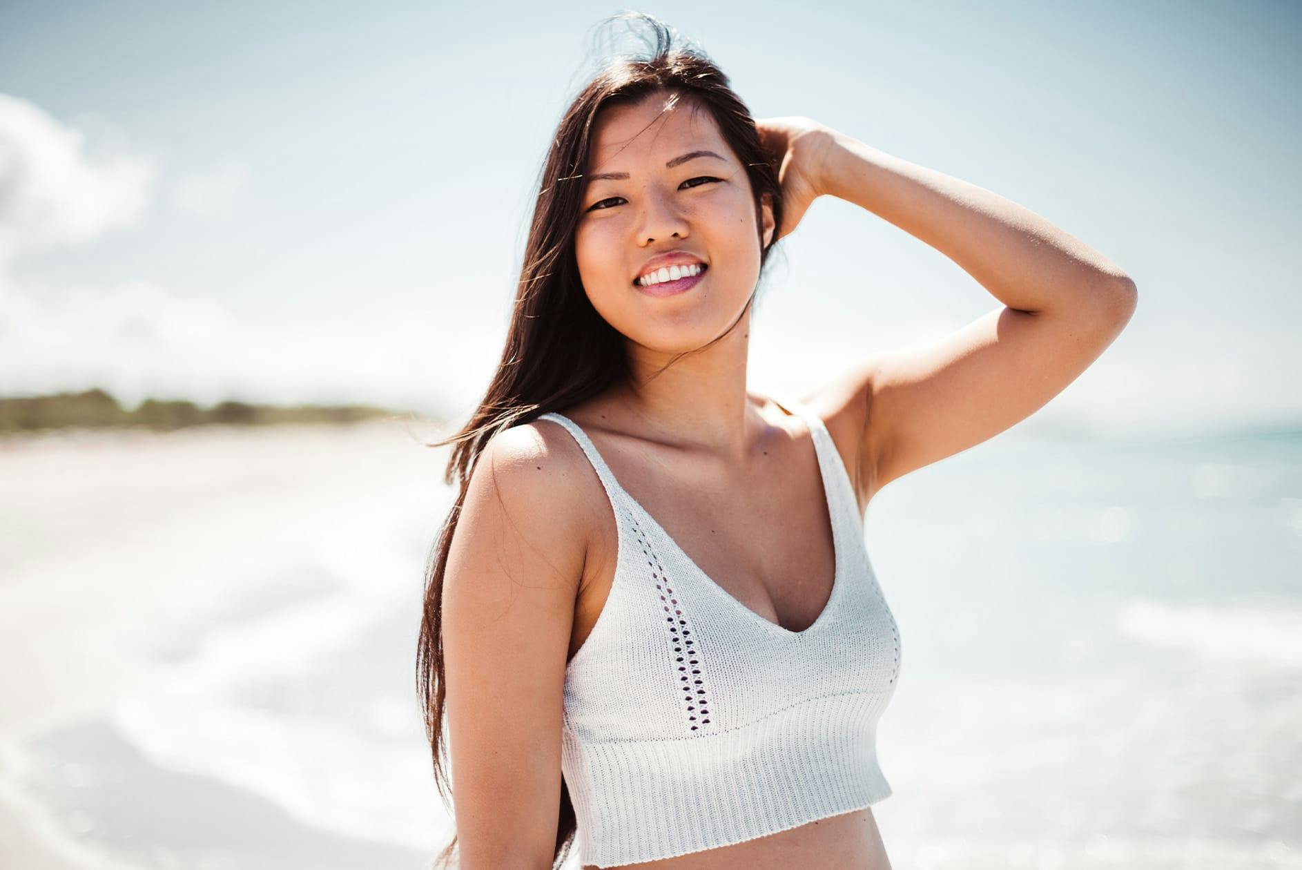 Woman in white top at beach