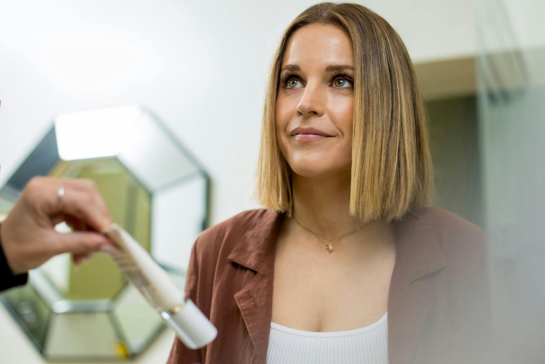 Woman being shown skincare product