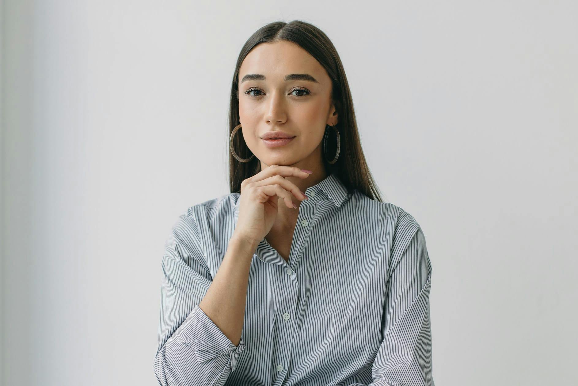 Woman touching chin and smiling