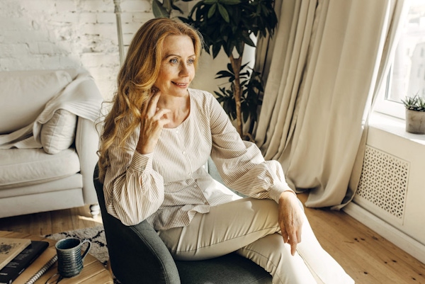 smiling woman in white outfit