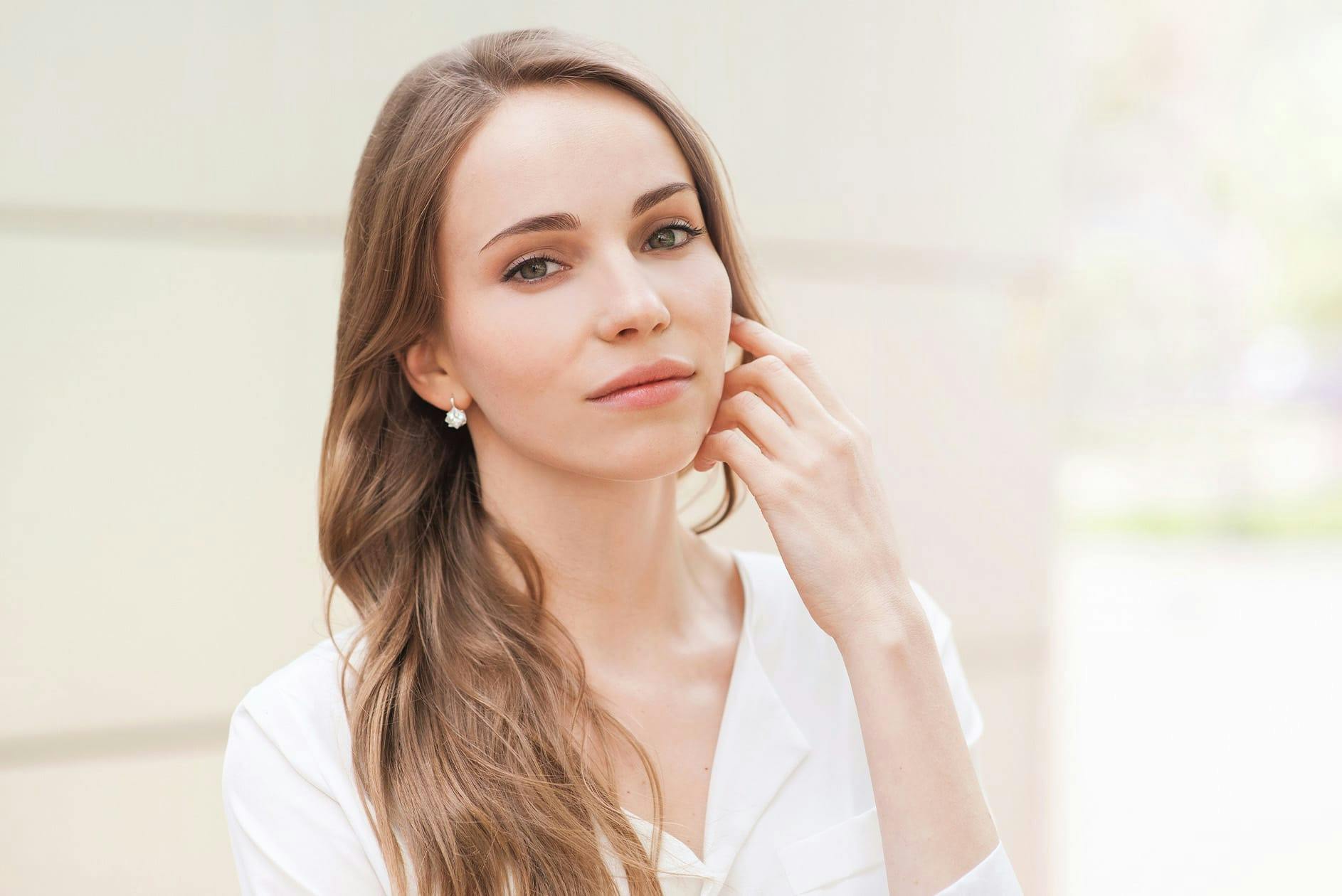 Woman brushing hair back