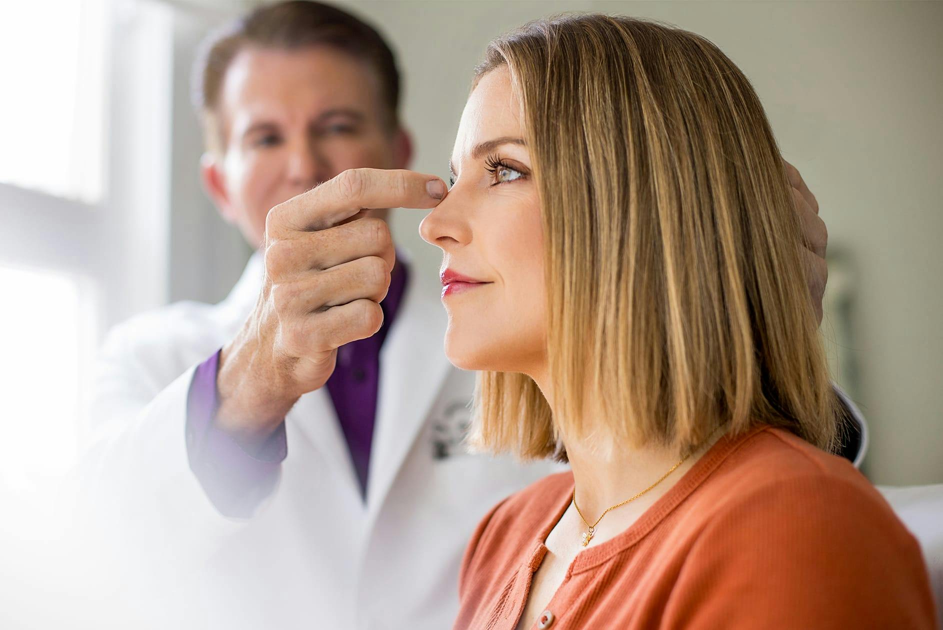 doctor pointing to a patient's nose