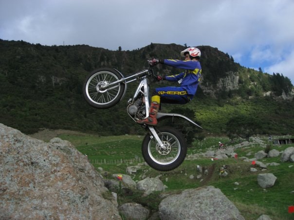 Phil doing big jump between rocks on trials bike