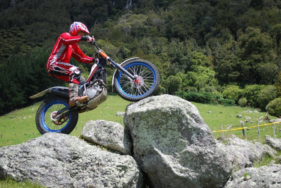 Phil riding over rocks on trials bike