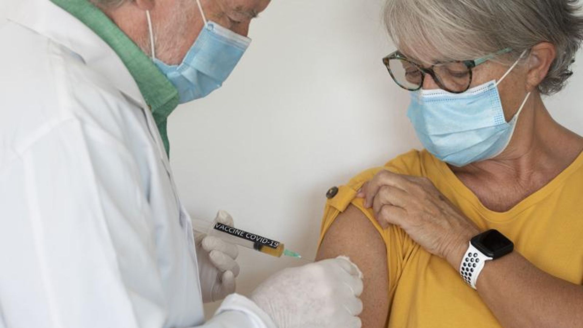 dr administering covid vaccine