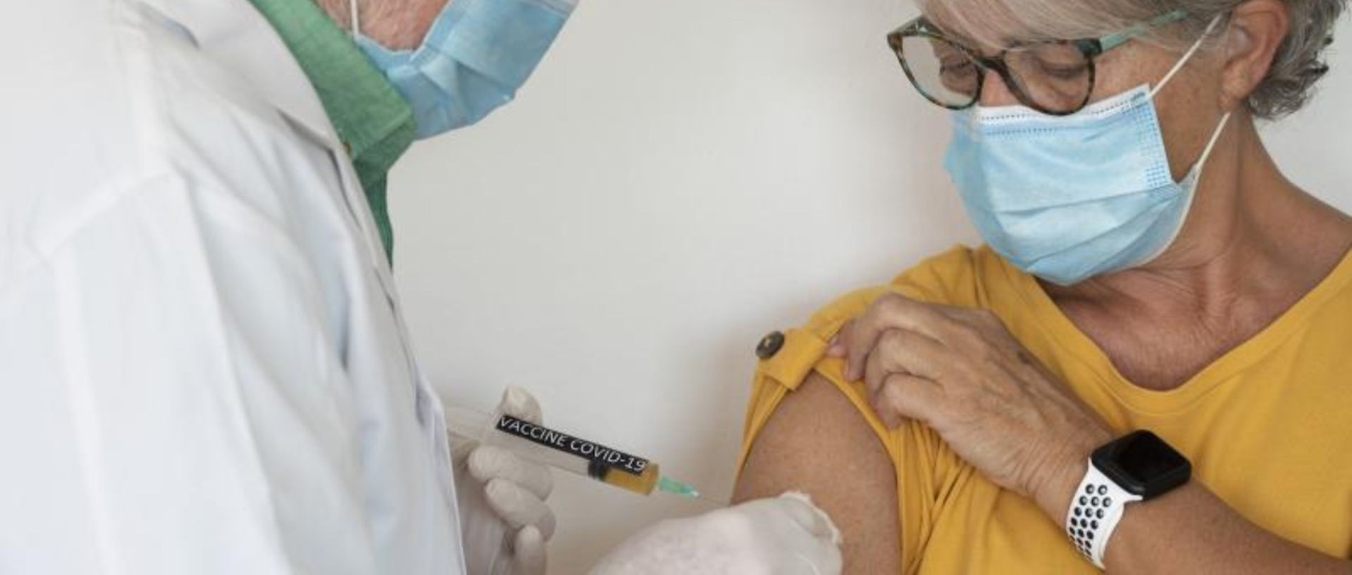 dr administering covid vaccine