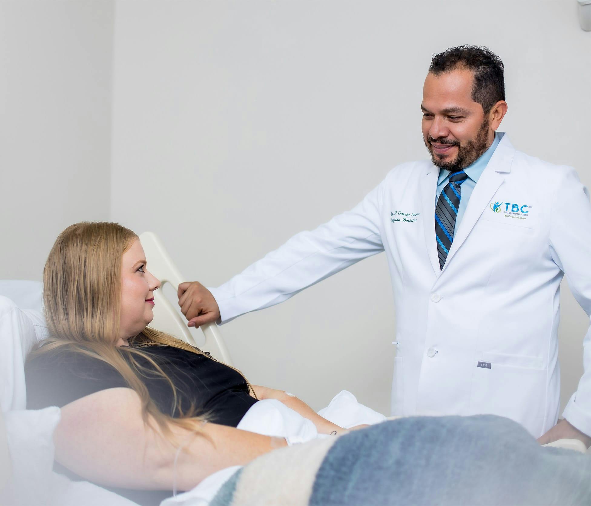 Dr. Fernando Garcia Govea standing next to patient