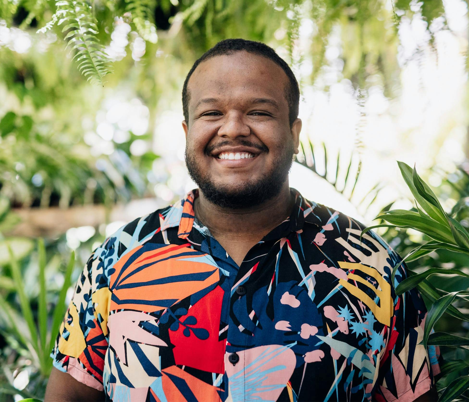 Man smiling and standing outside