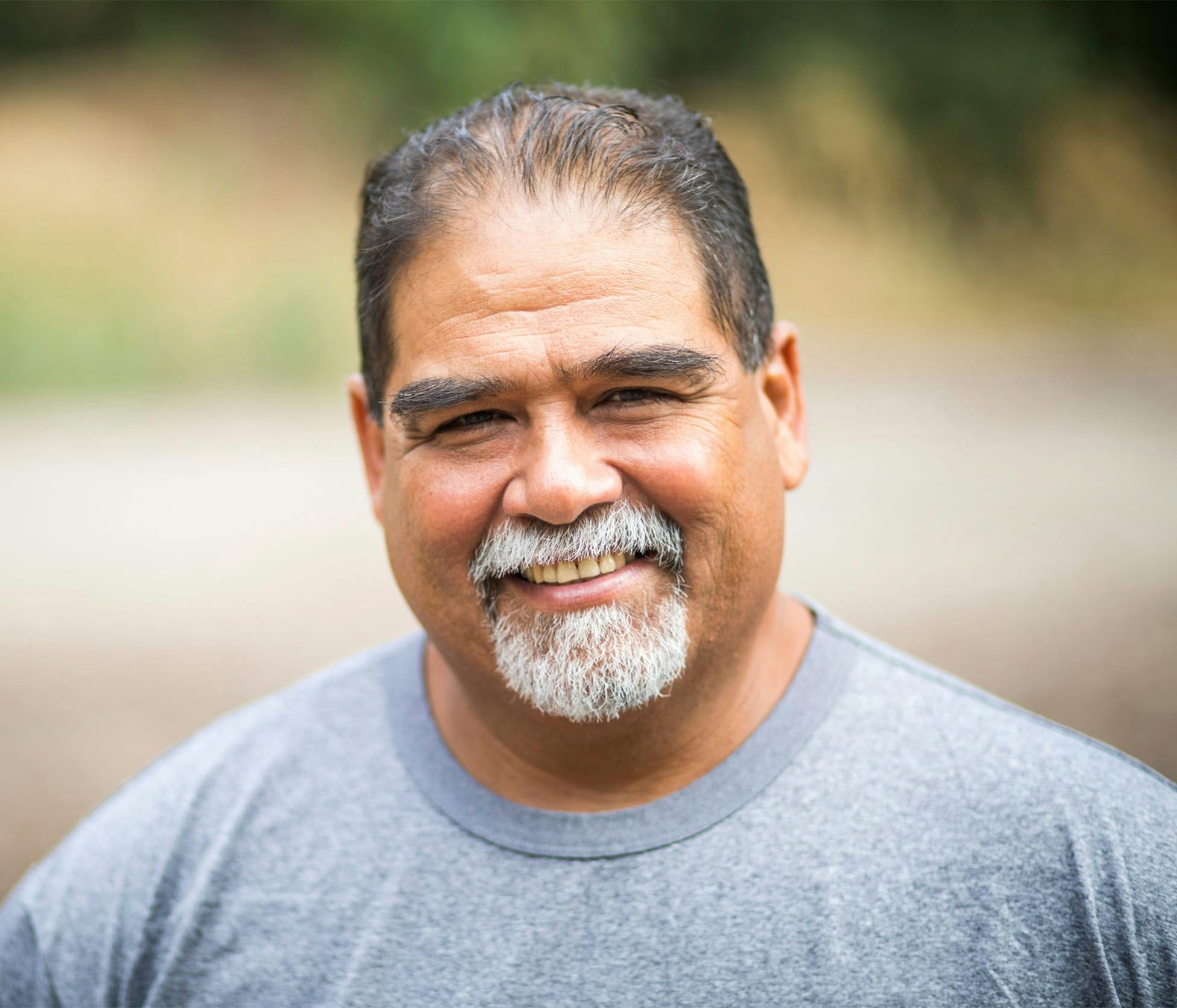 Man smiling and taking a walk outside