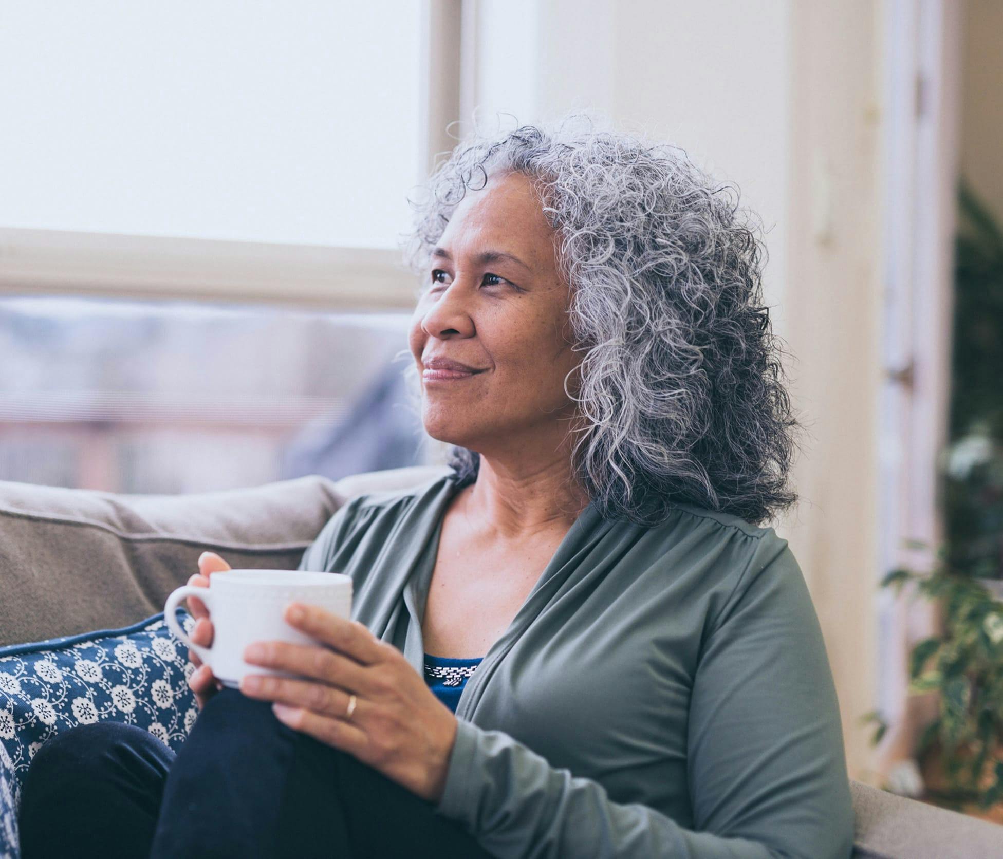 Woman smiling and holding tea