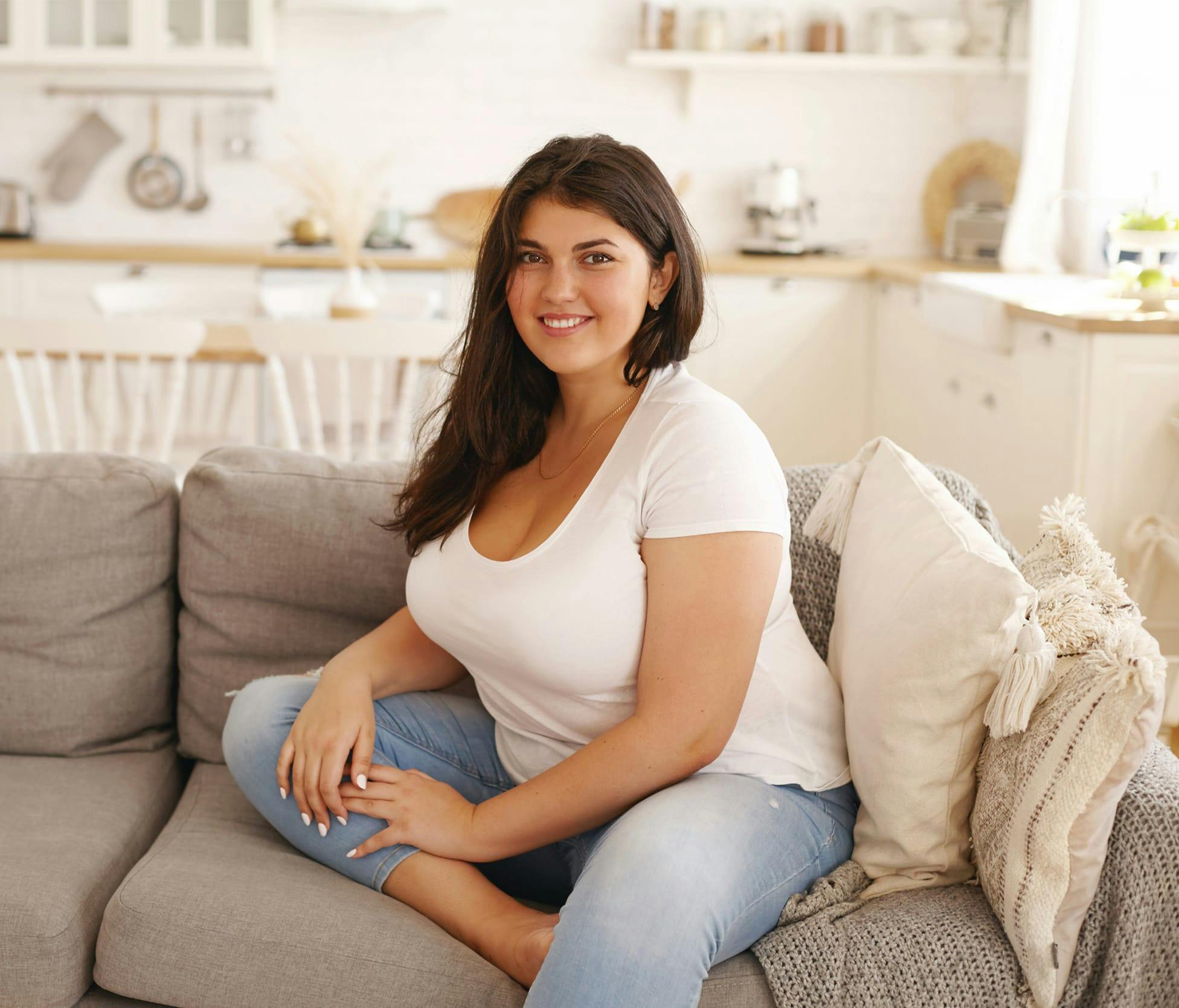 Woman smiling and sitting on the couch