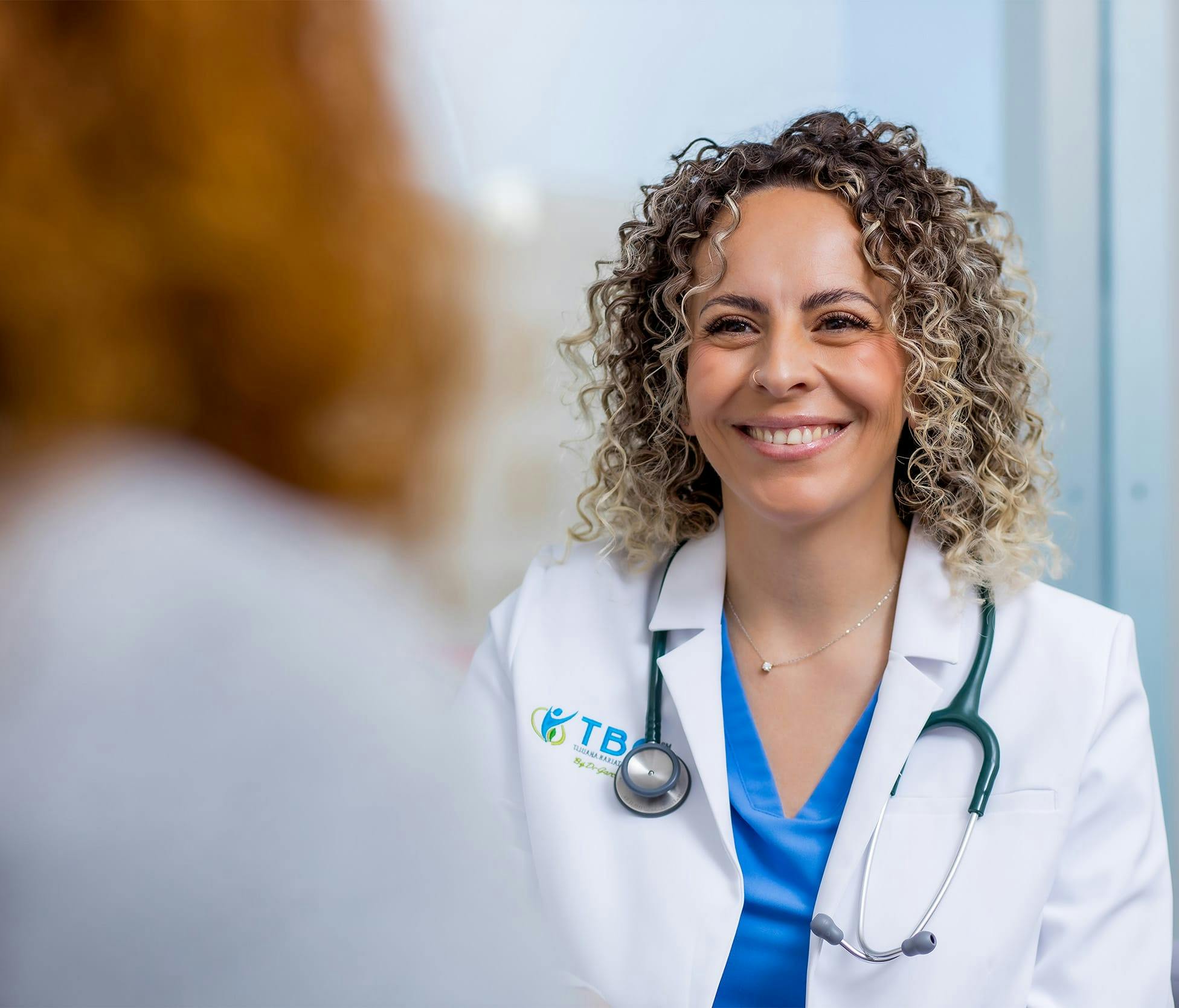 Doctor smiling and speaking with patient