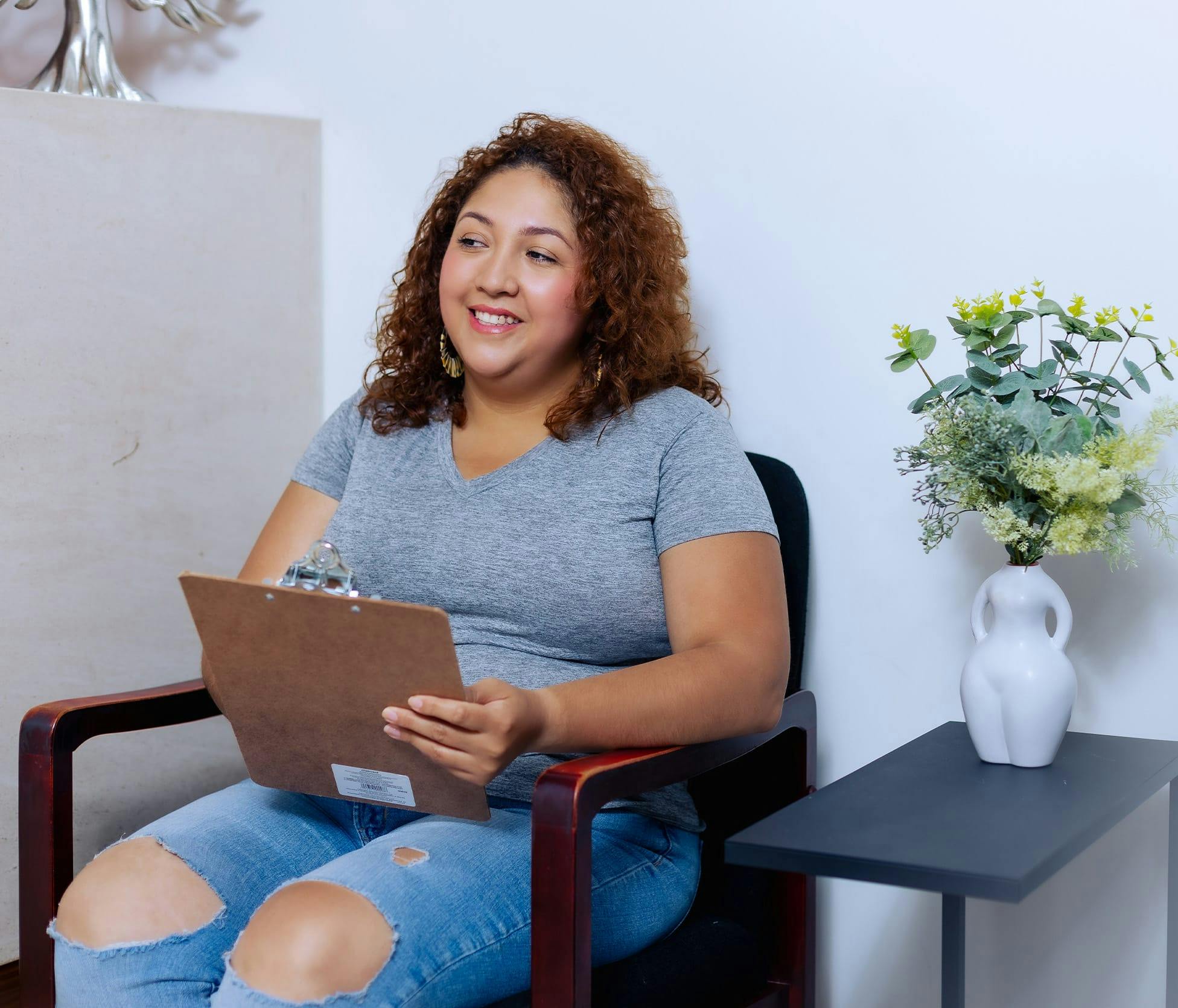 Patient smiling and holding clipboard