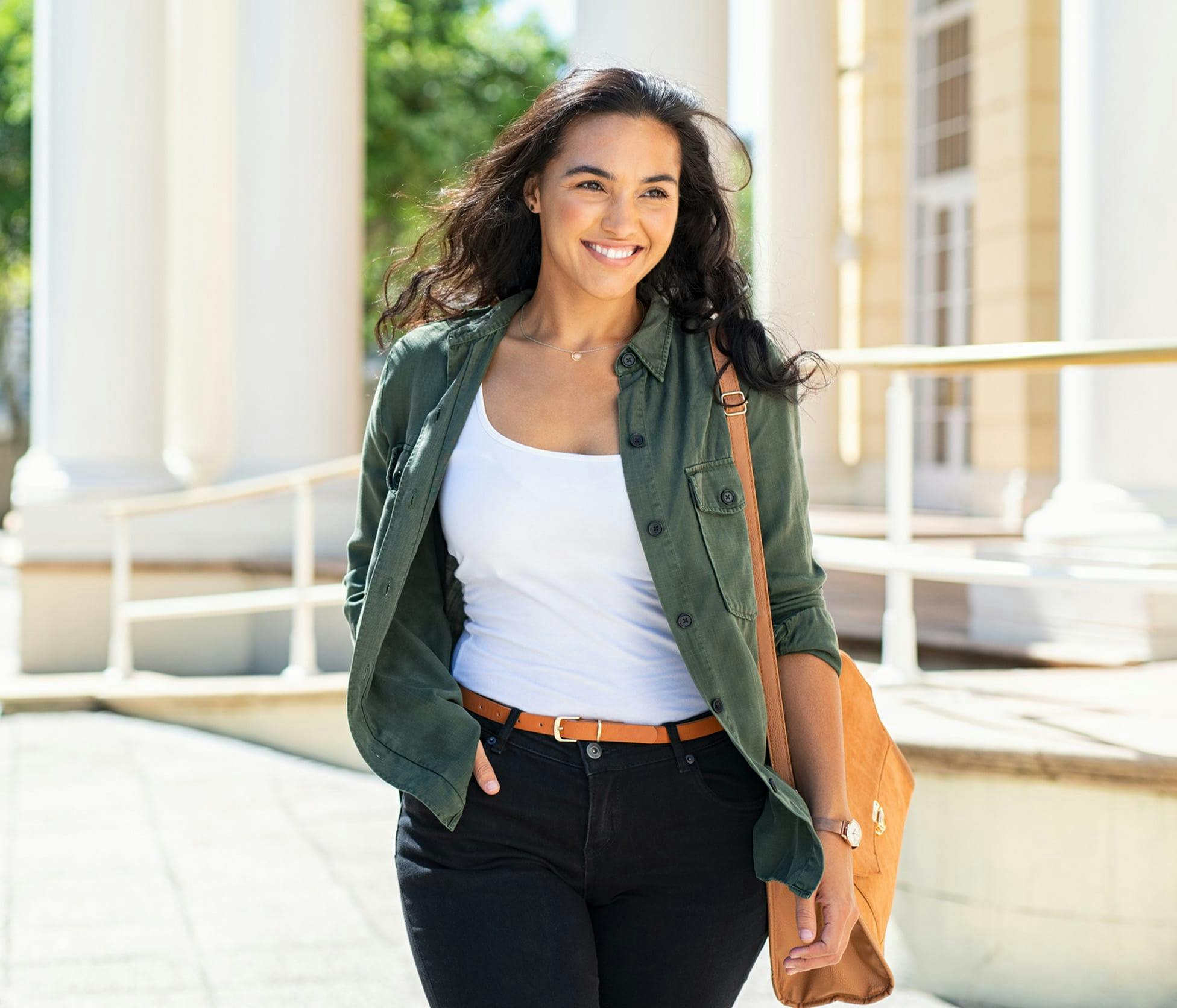 woman smiling and and walking outside with confidence