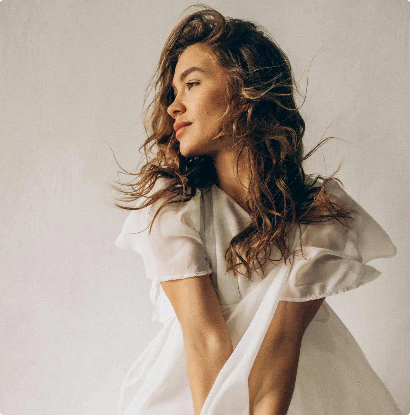 Woman in a sheer top looking to the side