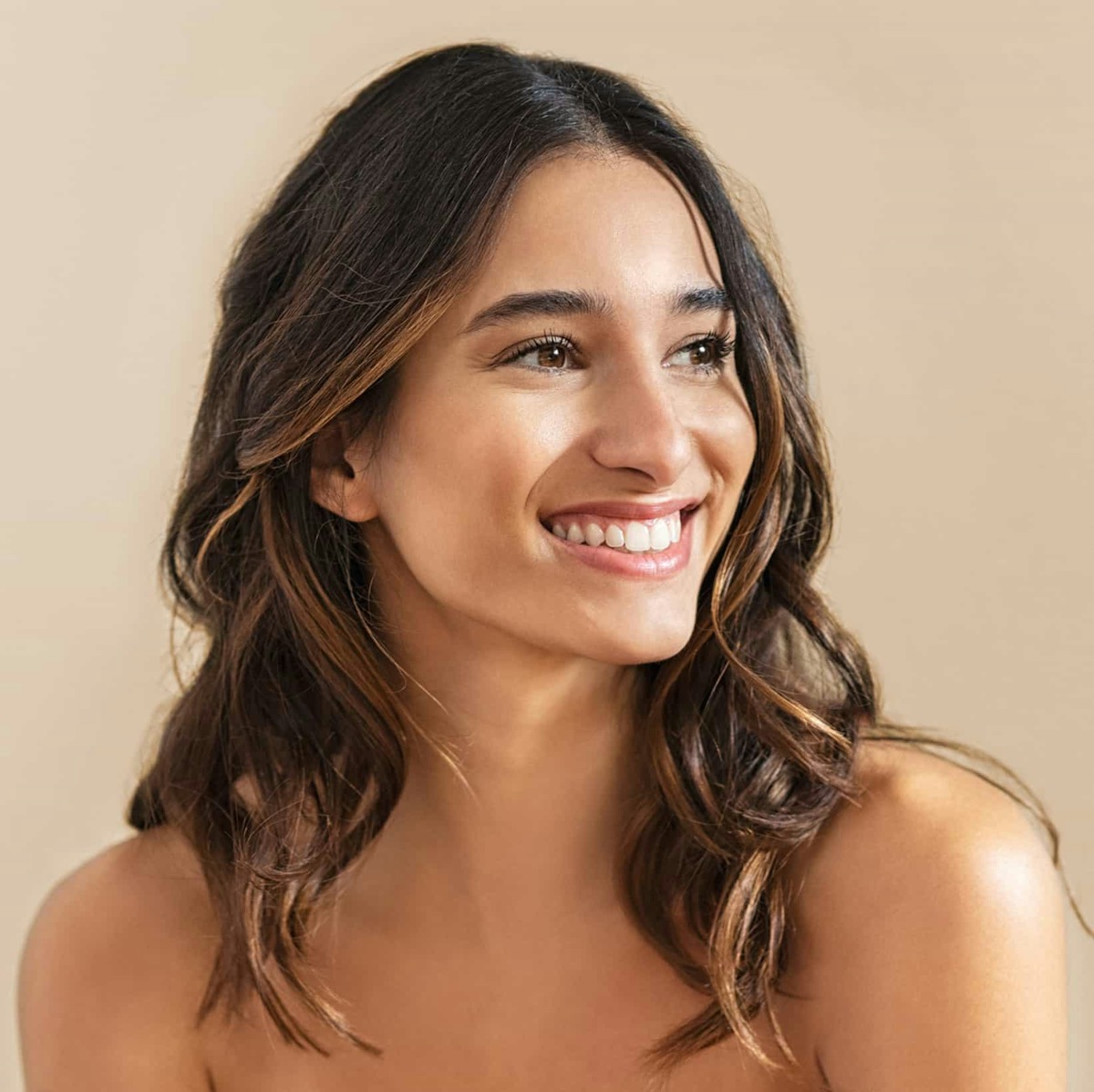 woman with brown curly hair smiling