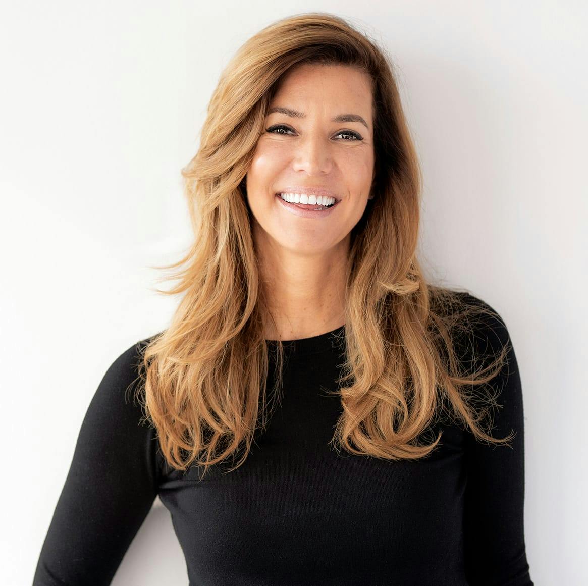 woman with long hair smiling