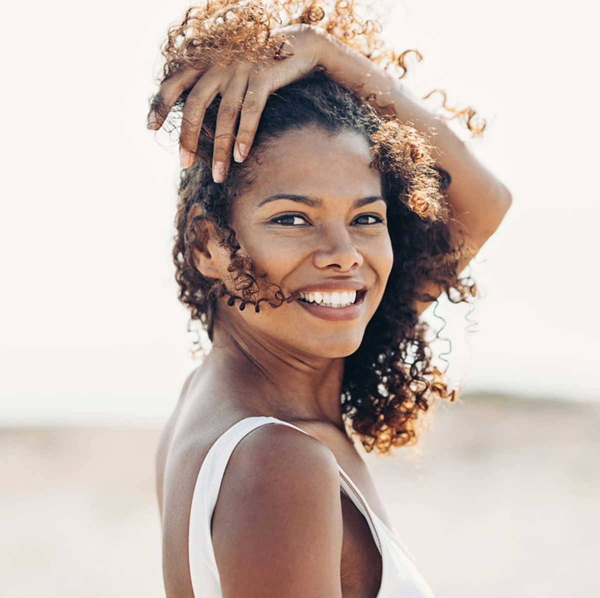 woman with blonde hair wearing a white button up top