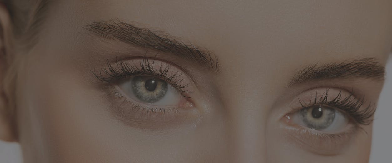 Close up on a woman's upper half of her face. She has gorgeous eyes and lifted eyebrows to emulate the potential results of a brow lift in McKinney