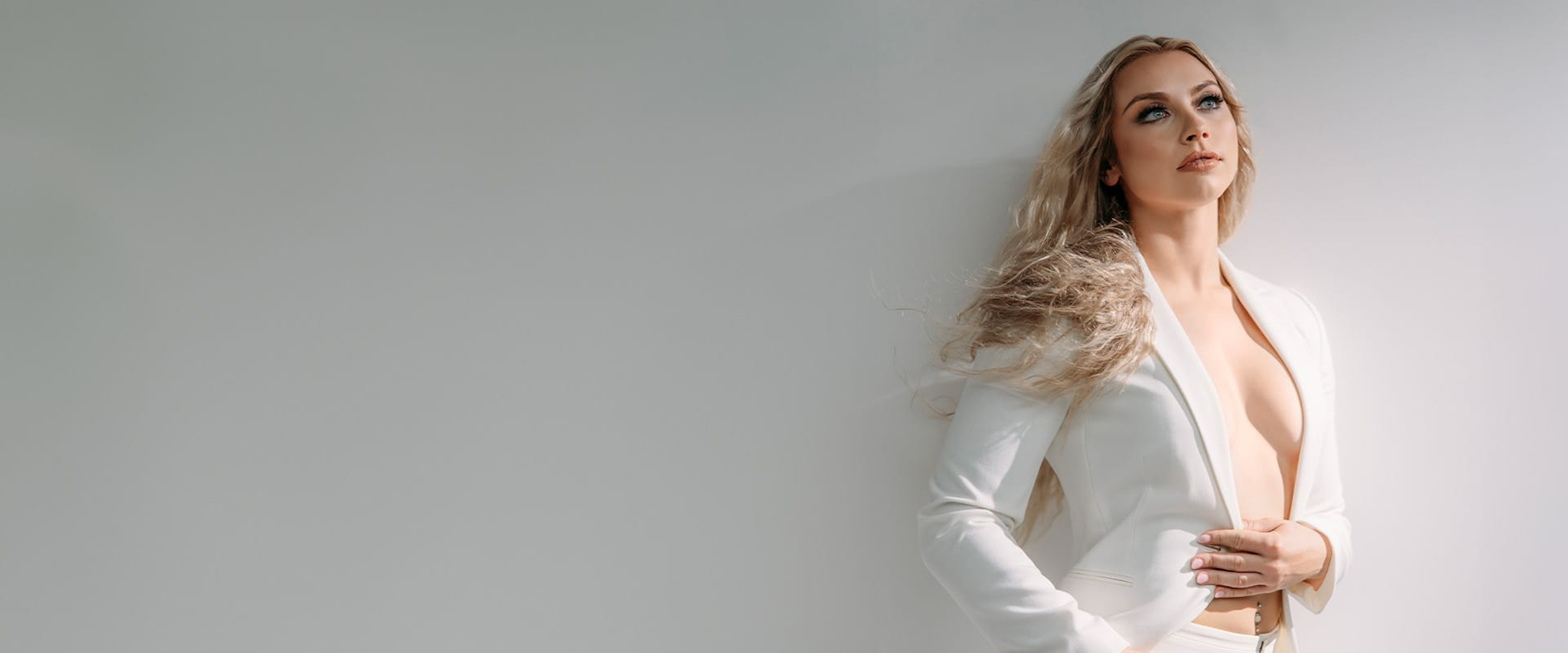 Woman posing in white blazer