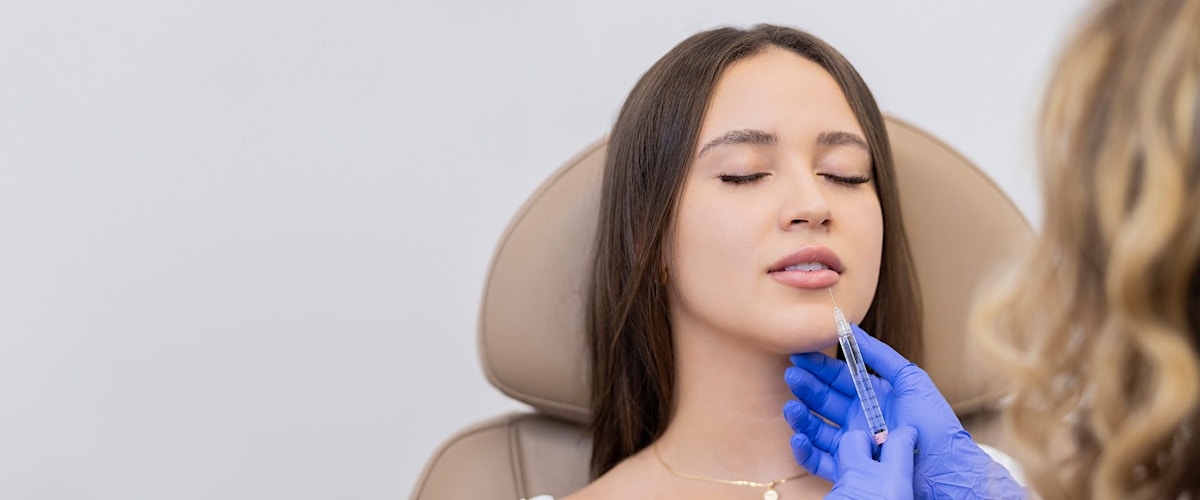 Woman receiving lip injection