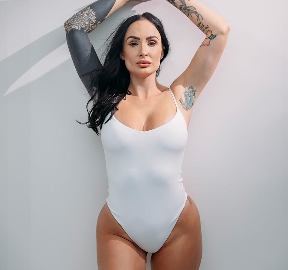 Woman posing in white leotard