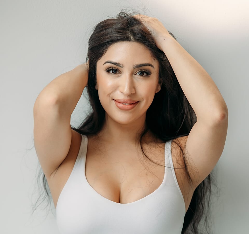 Smiling woman touching chin