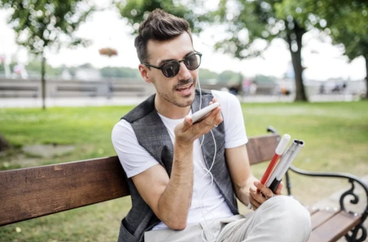 Man in park with smartphone