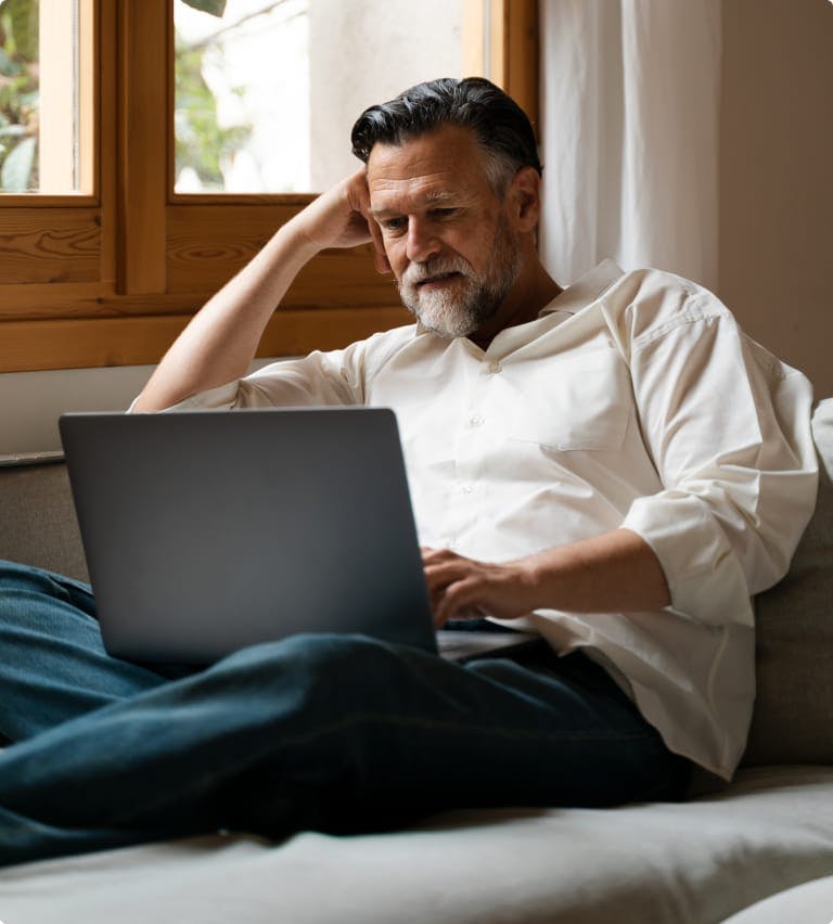 Man on his laptop on a couch