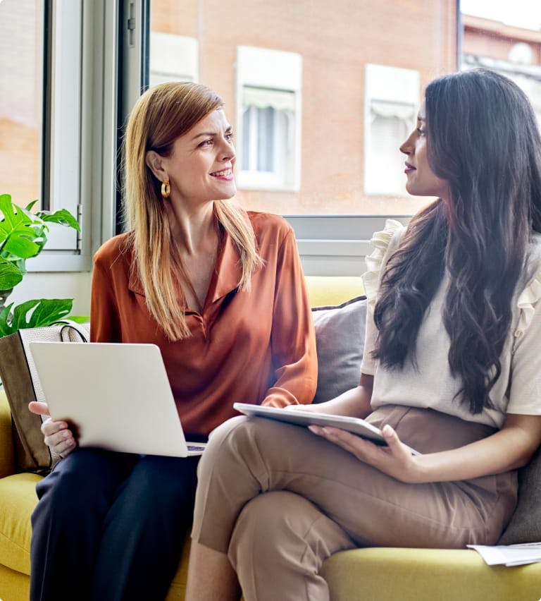 Two women sitting on a couch