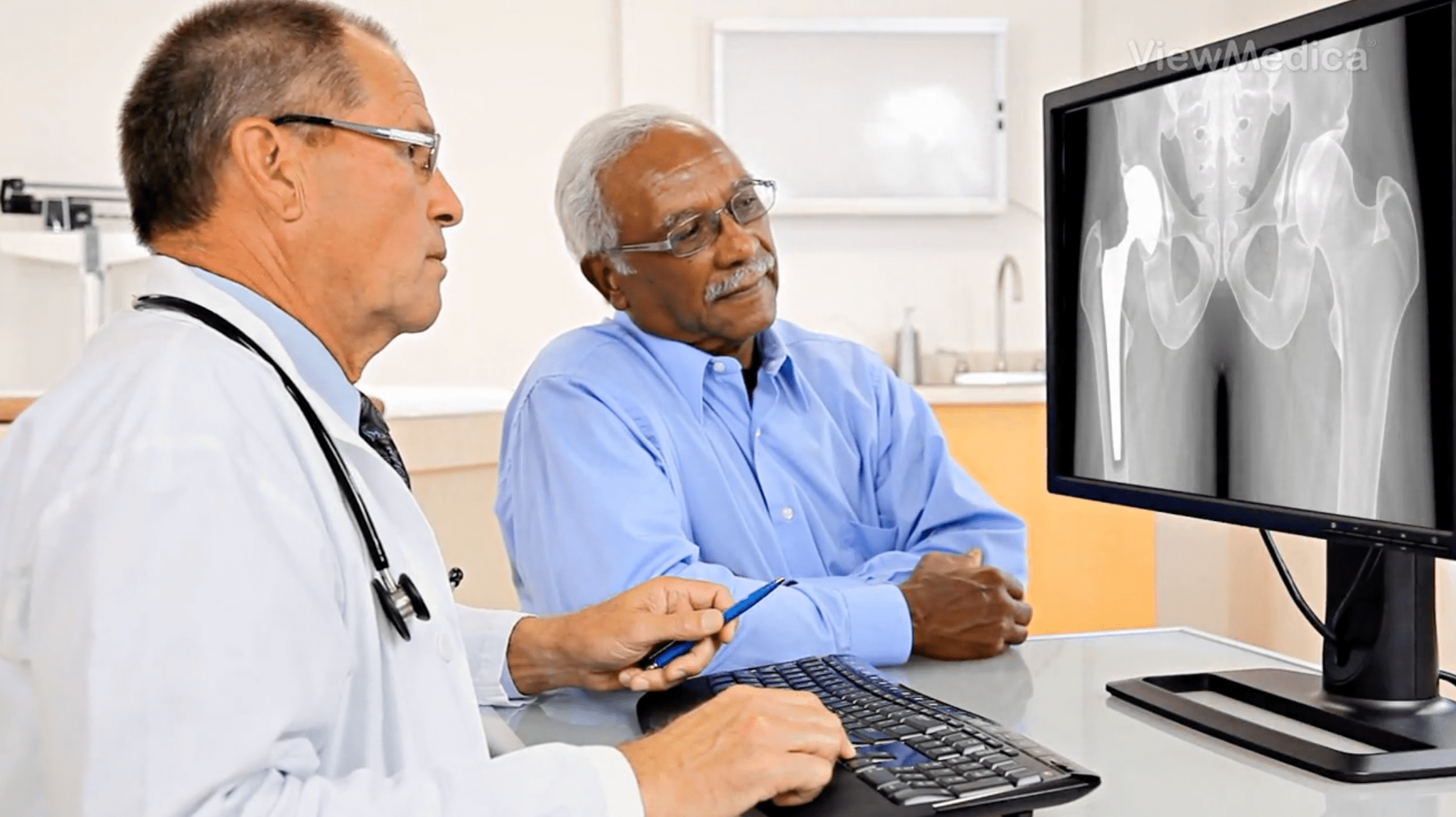 Two men sitting at a computer