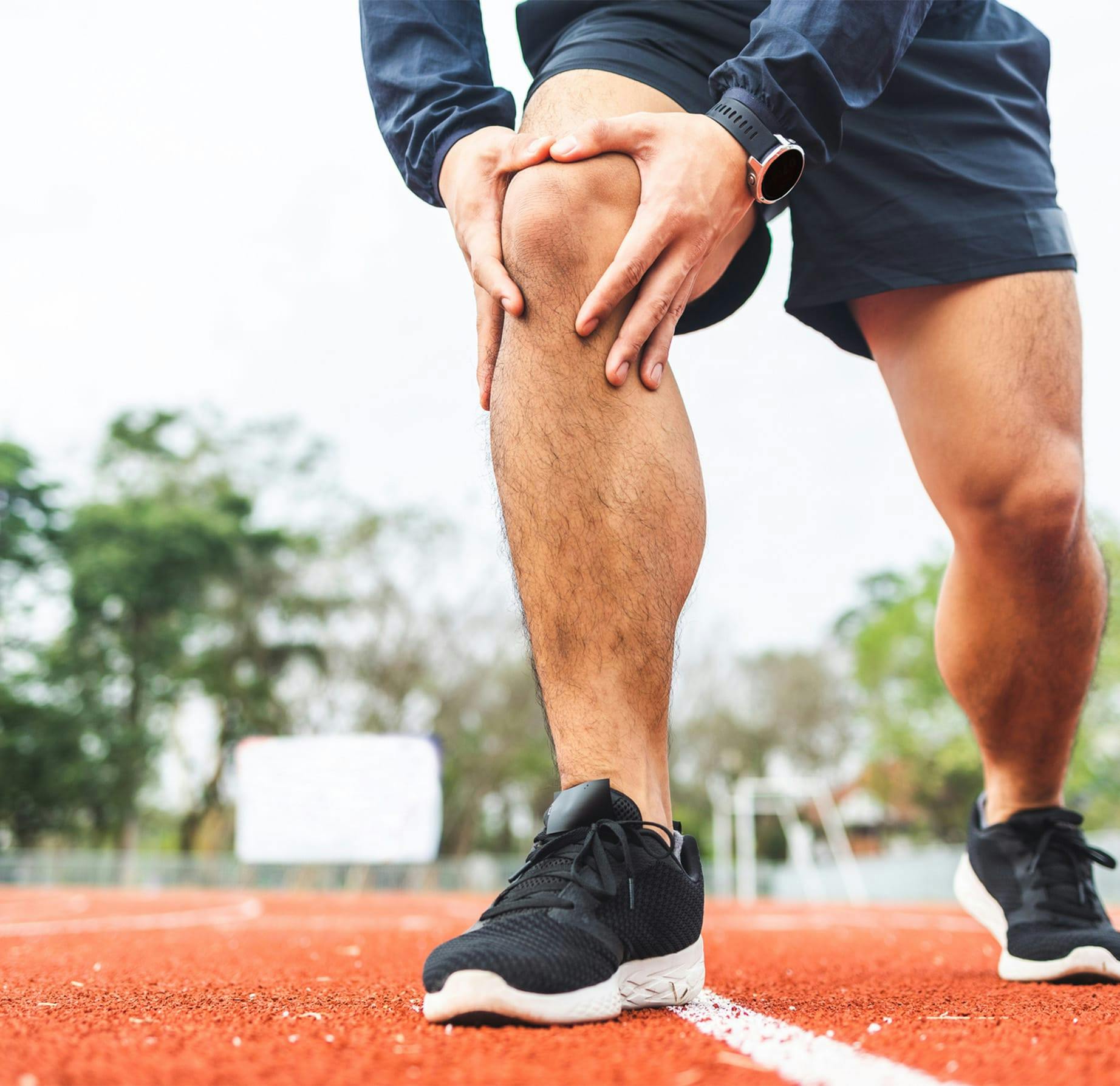 runner holding his knee